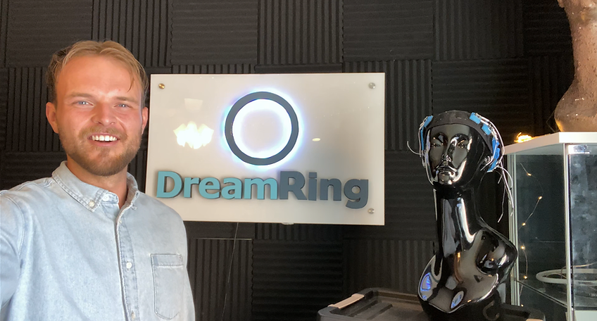 Mitch Jorgensen, founder of DreamRing Labs, smiling surrounded by DreamRing devices.